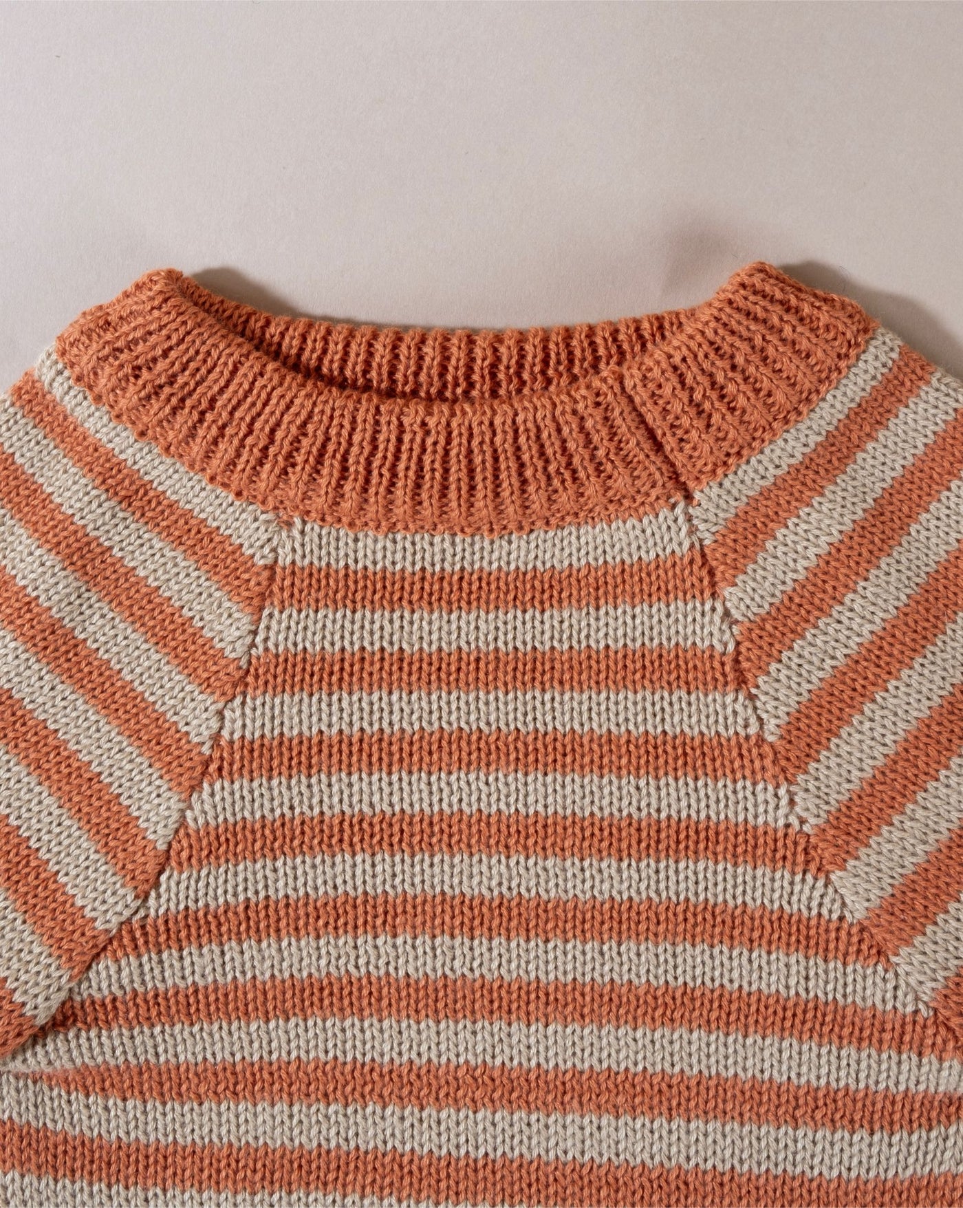 Boxer dog sweater - enjoying an outdoor adventure in a orange knit stripe dog sweater built for durability.