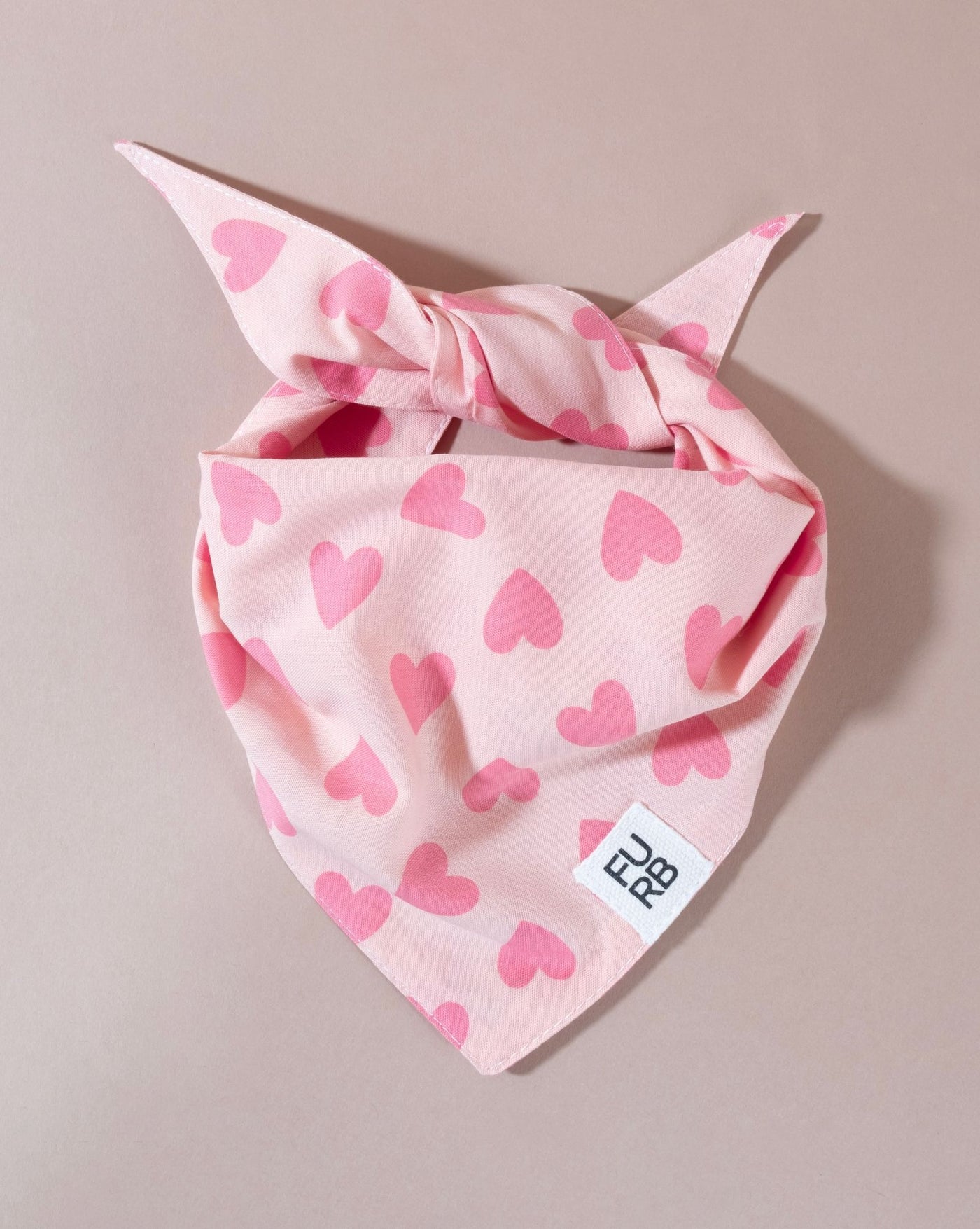 Pink heart print bandana for your dog, perfect for breeds like Shih Tzus and Dachshunds