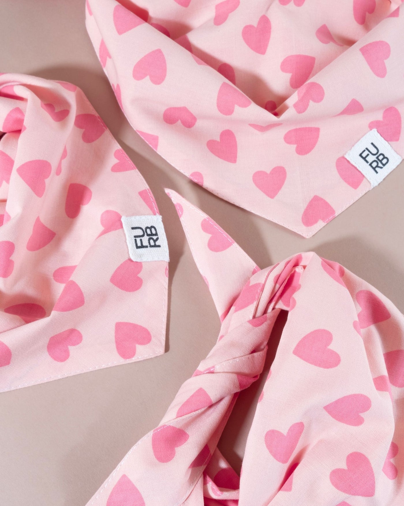 Soft pink heart-patterned bandana for stylish pups, ideal for Beagles and Cocker Spaniels