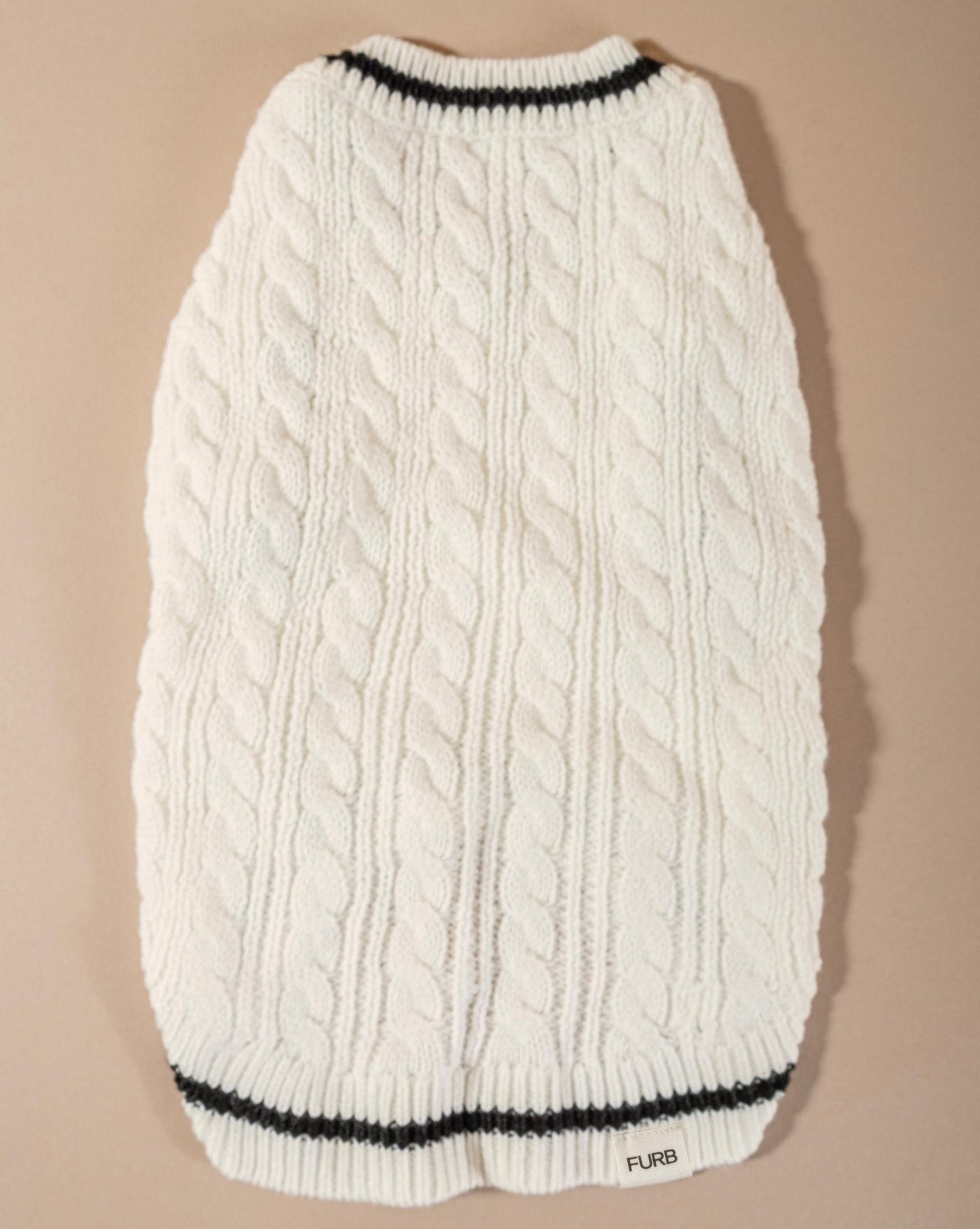 Chic ivory cable knit sweater vest for small and medium dogs, an essential wardrobe item for cooler days.