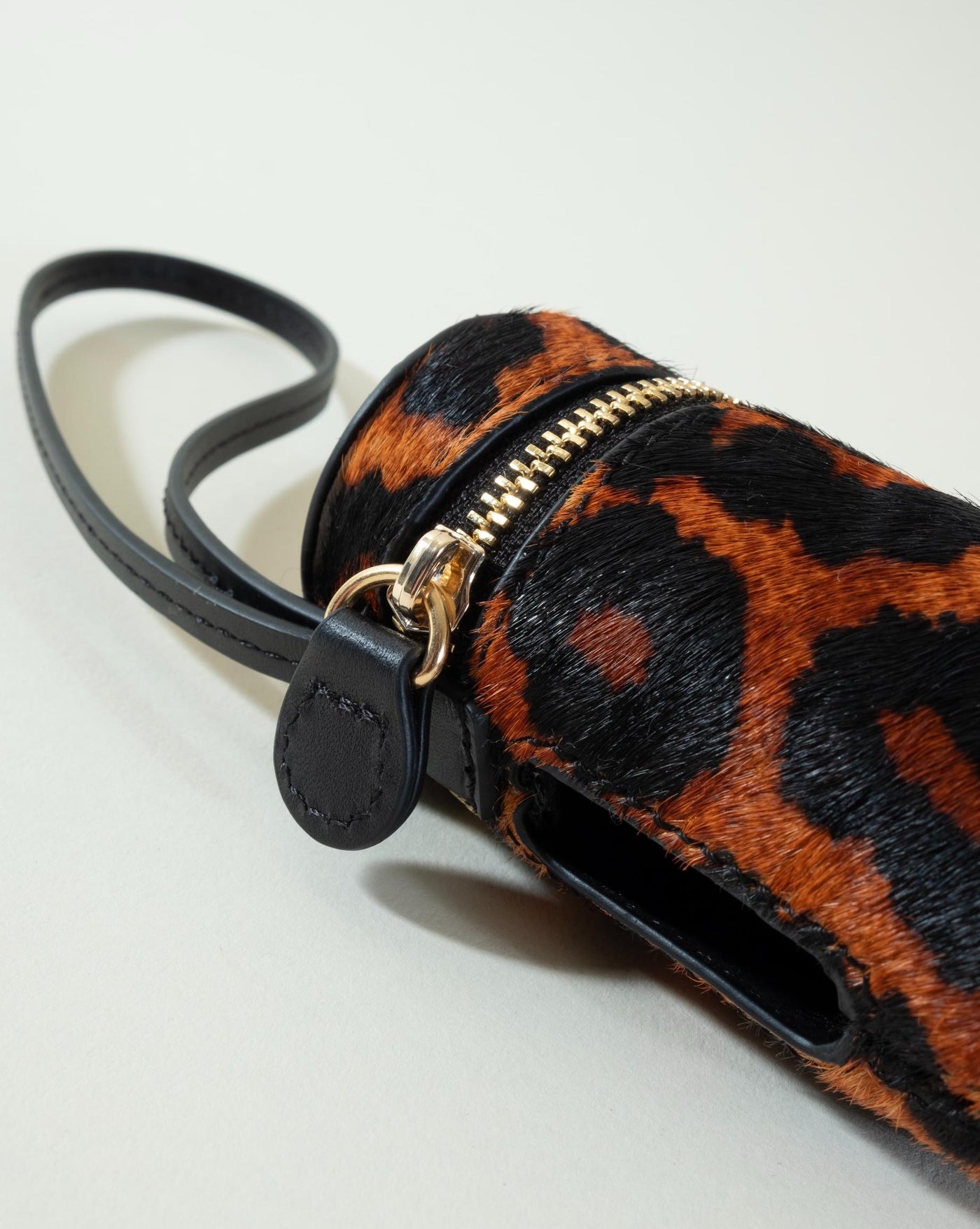 Black leopard print poop bag holder, perfect for small and medium dogs with a wild sense of style