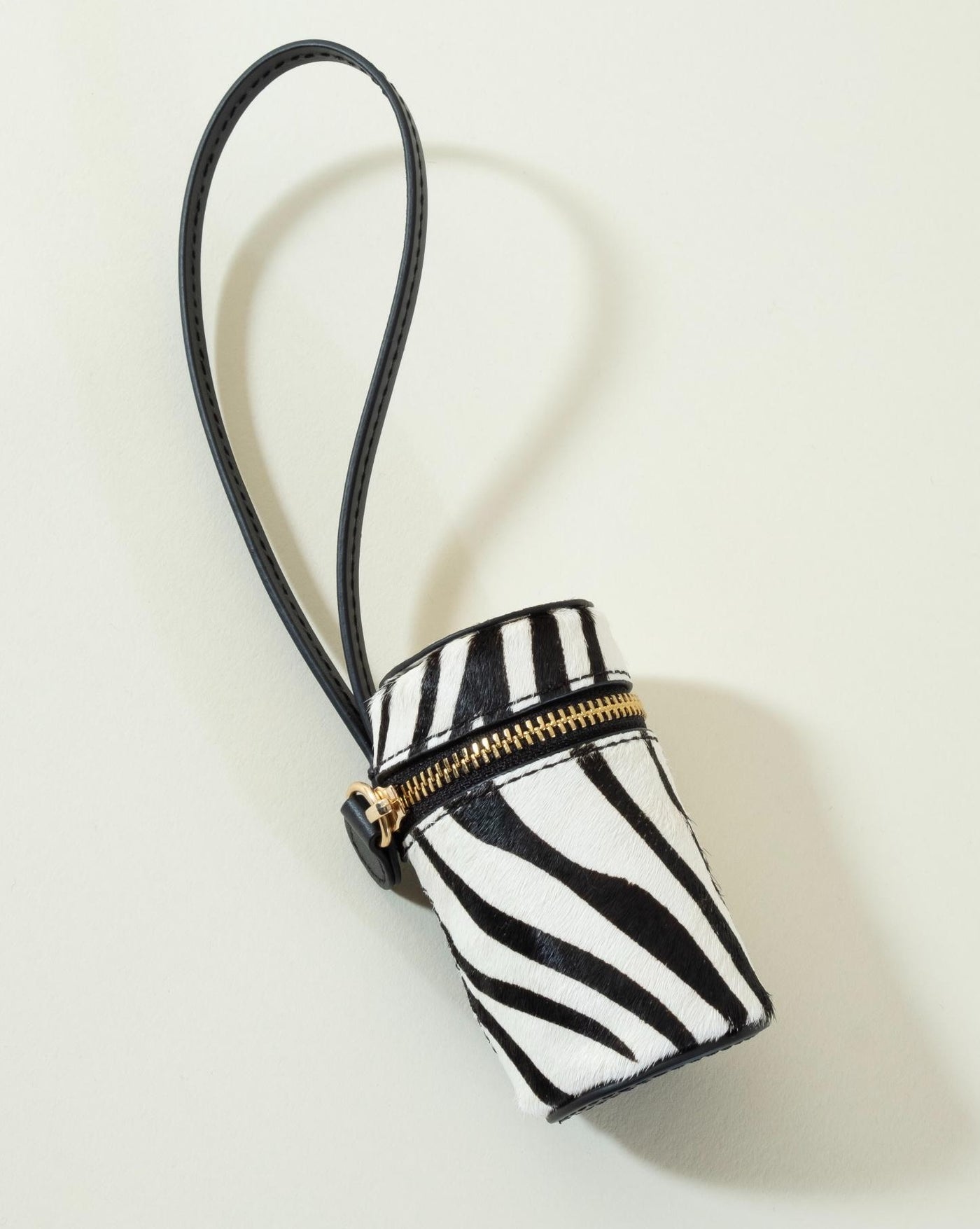 Stylish black zebra print waste bag holder for small and medium dog breeds, perfect for walks and outdoor adventures