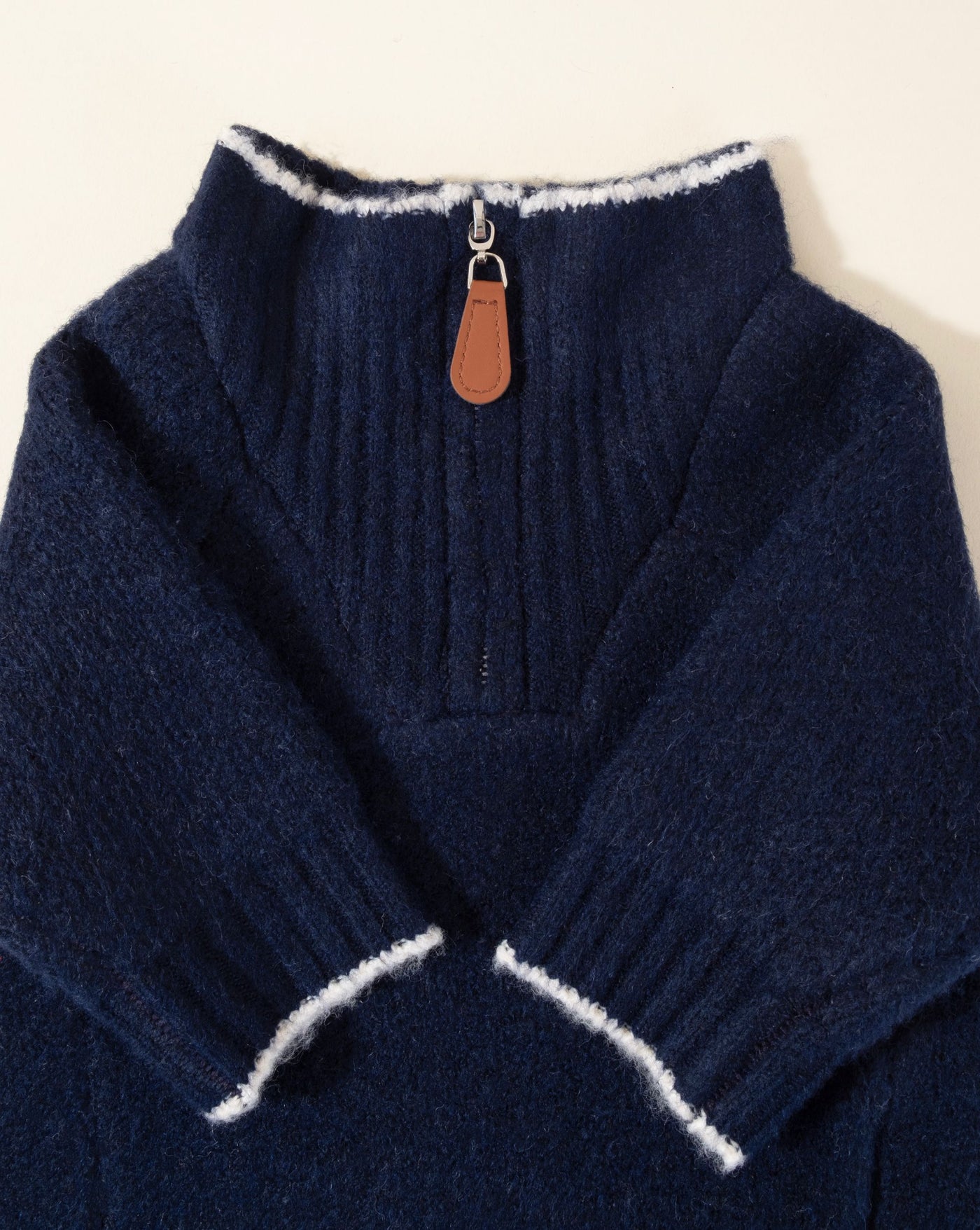 Navy blue sweater for dogs featuring a nautical anchor design, perfect for seaside outings