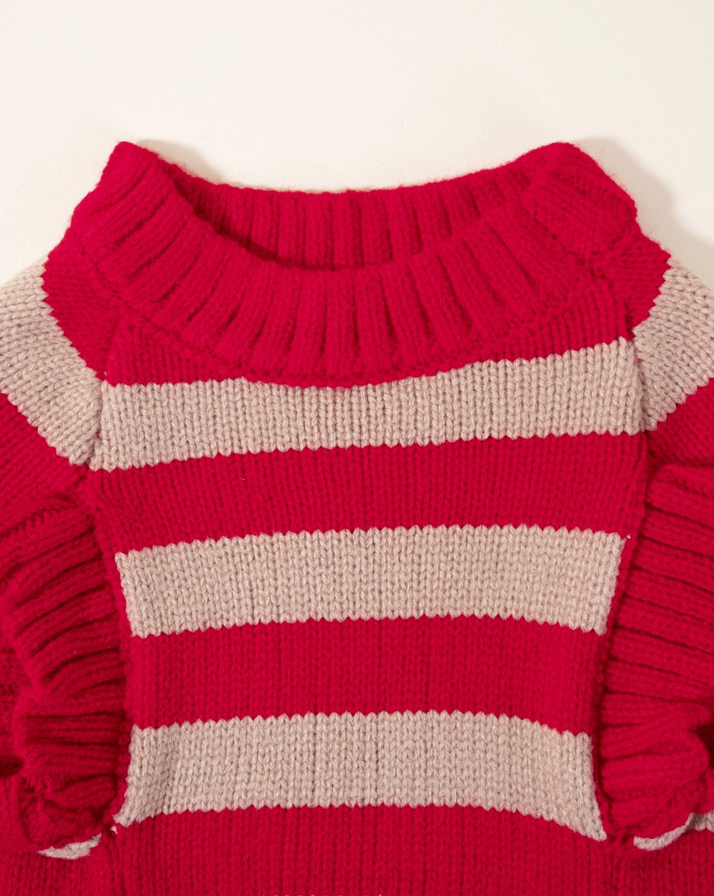 Stylish red striped sweater vest for dogs, offering comfort and warmth during chilly weather