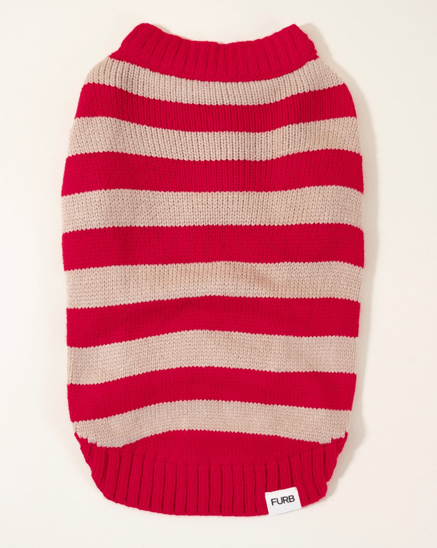 Dog sweater vest in red with candy stripe pattern, adding a playful and vibrant touch to your pet's style