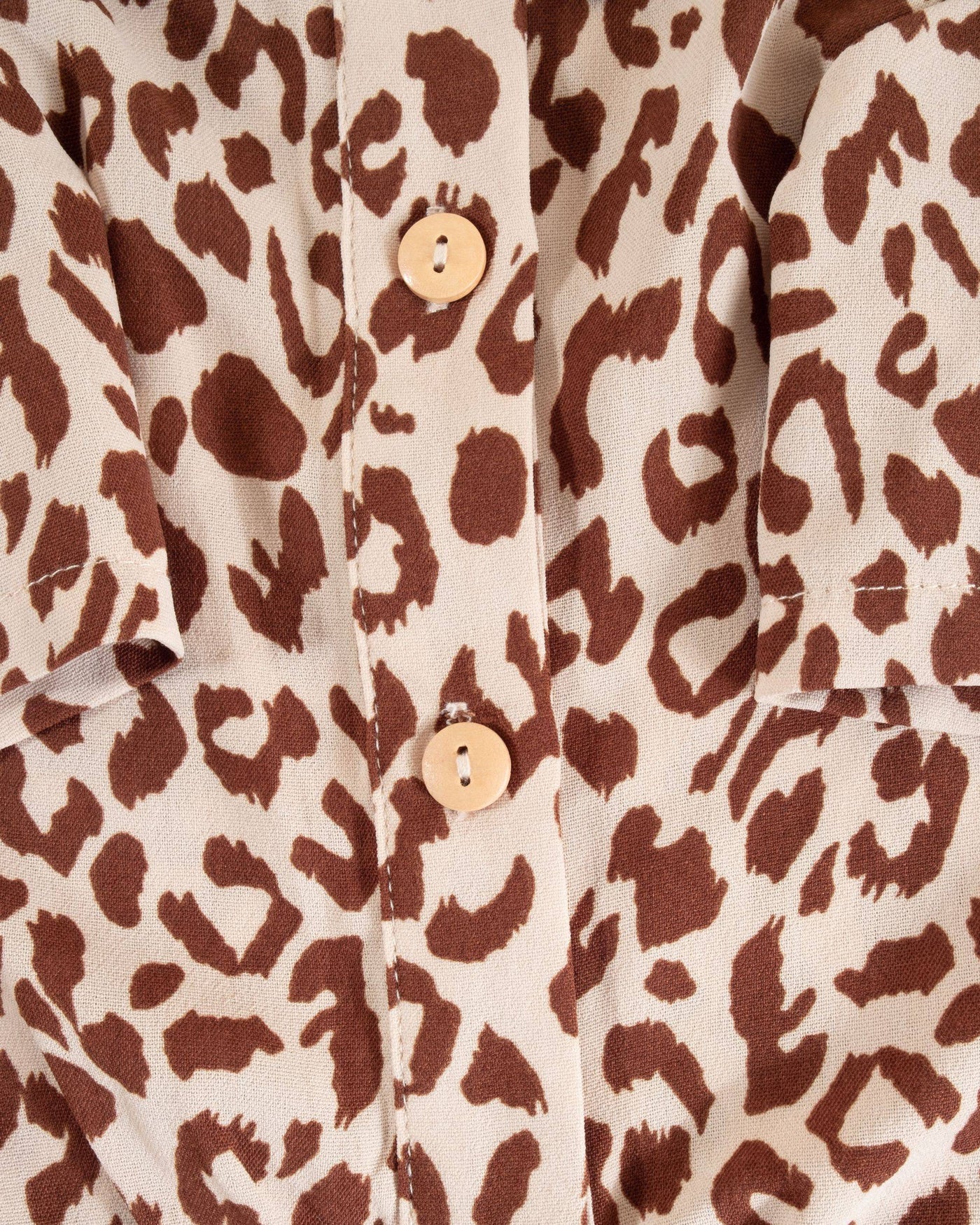 Leopard print shirt for small to medium dogs, perfect for a walk on the wild side with a button-up design