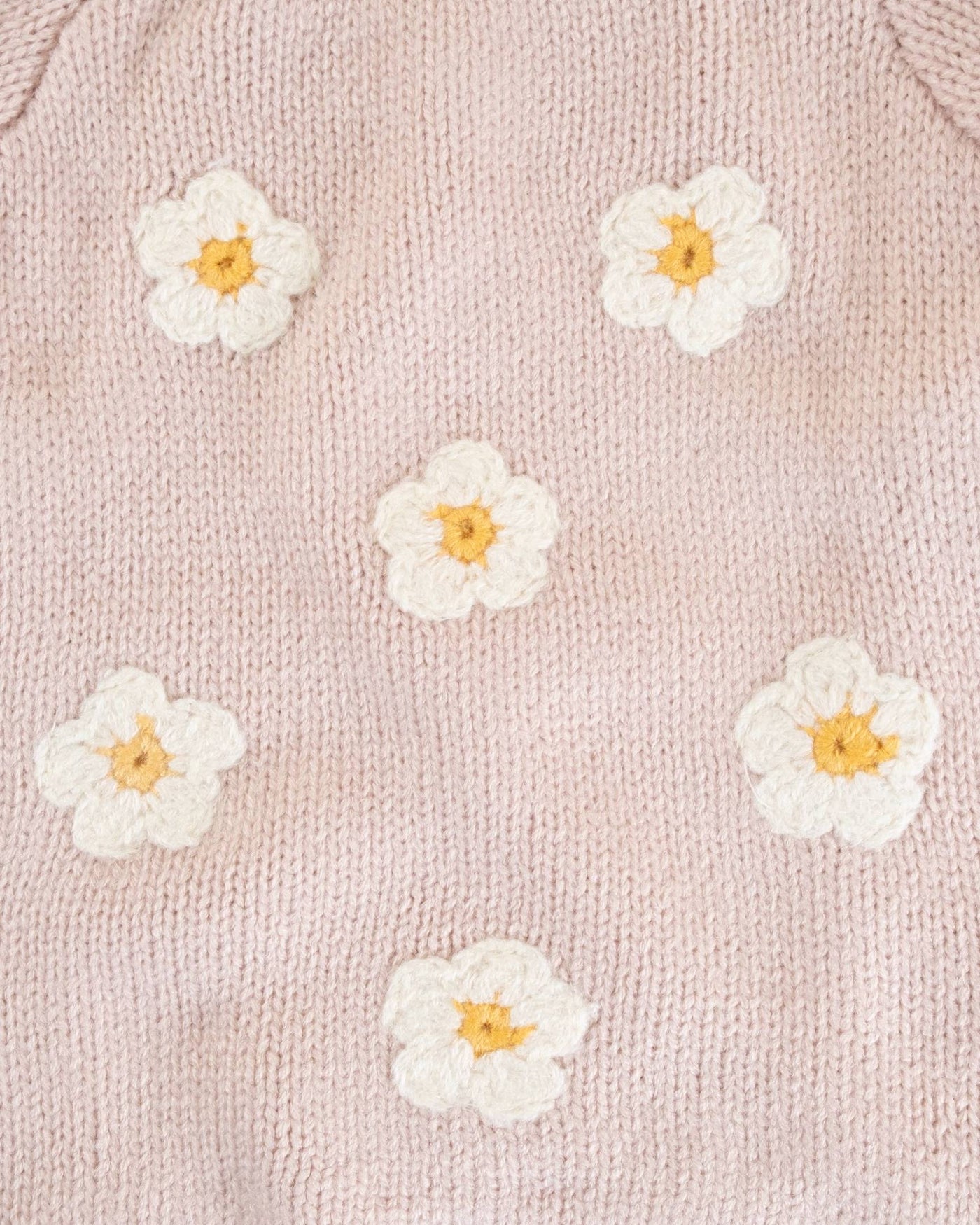 Delicate pink dog sweater with daisy accents, perfect for keeping small and medium dogs stylish and warm.