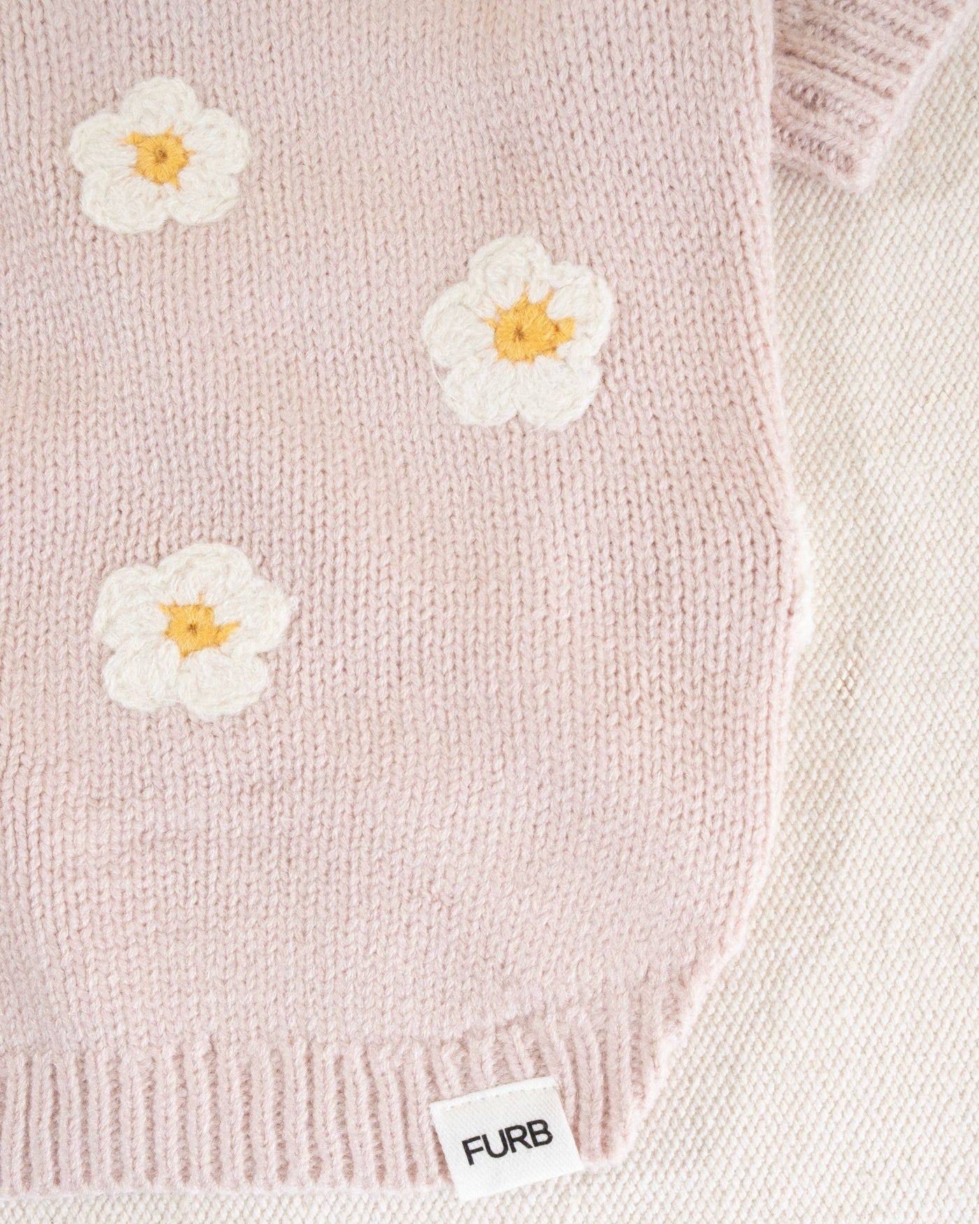 Blush pink daisy dog sweater for small to medium breeds, a cozy and cute choice for your pup.