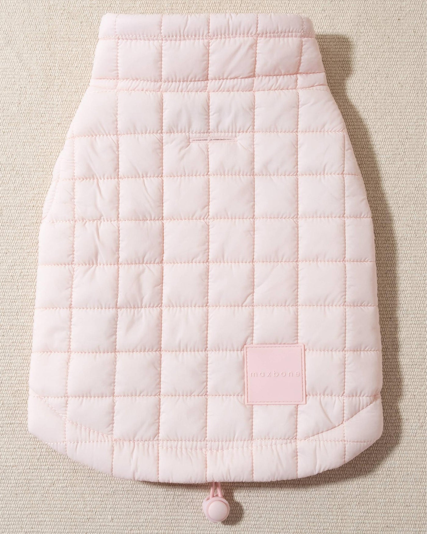 perfect on its own or layered with a cute sweater. This quilted, stylish jacket is fully adjustable, with coordinating light pink cords on the hem, neck, and arm openings. Jacket can be worn over harness, with a small opening for leash attachment on the back. Asymmetrical buttons also make for more secure wear, for even the most portly of pups!. Yorkie pink jacket.