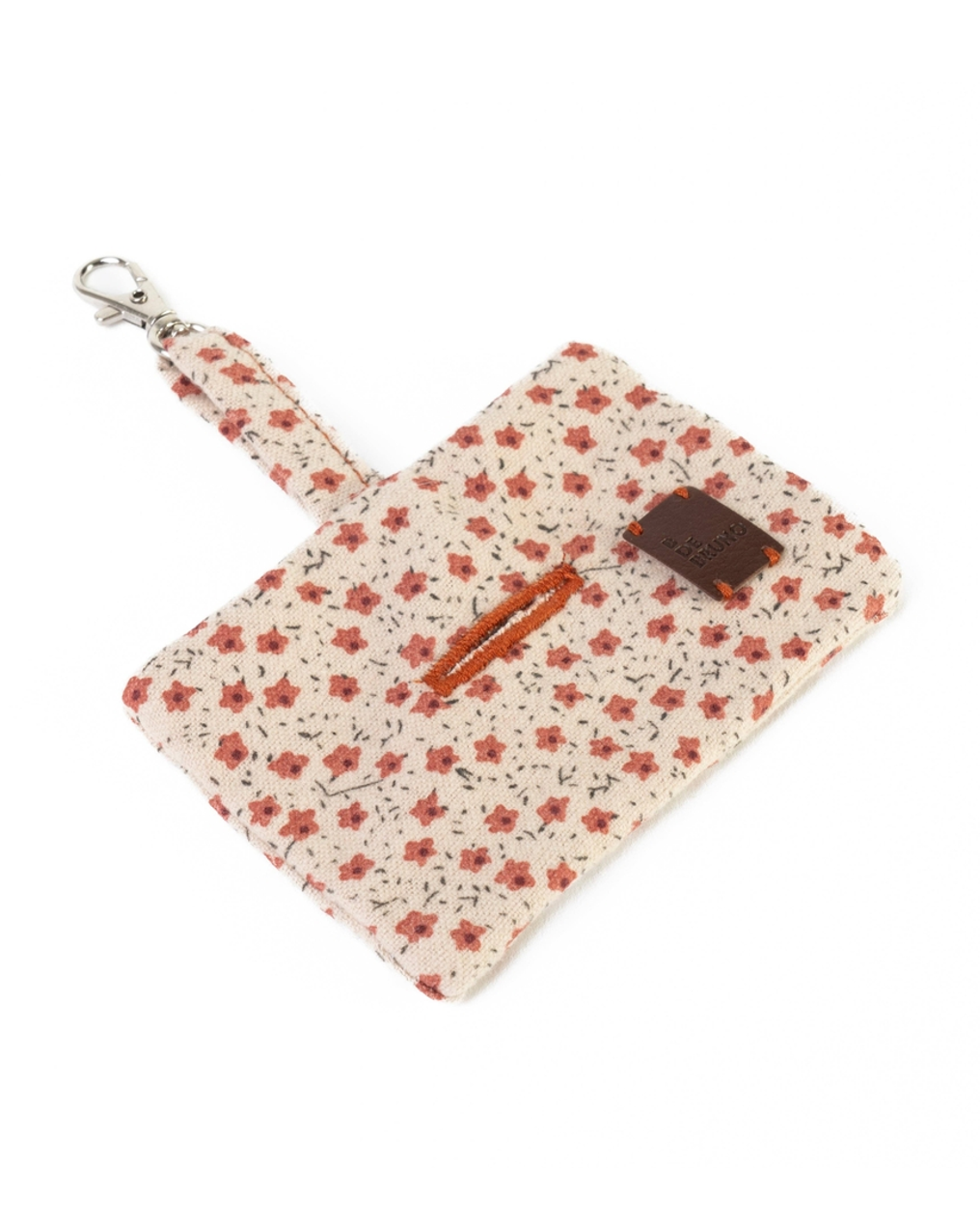 Convenient red floral waste bag holder for small and medium-sized dogs like Terriers and Beagles.