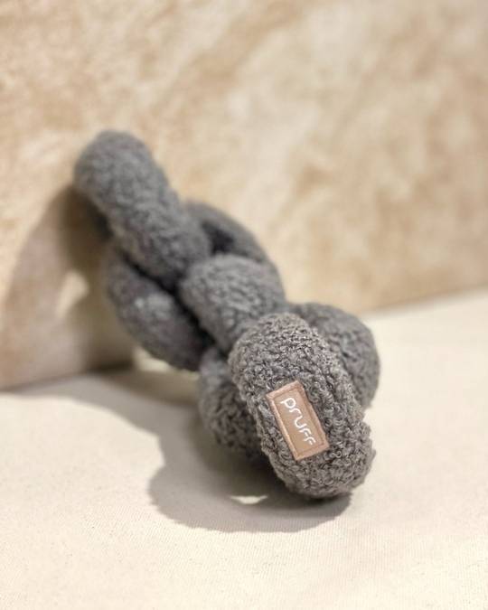 Durable grey plush dog tug toy designed for small to medium breed dogs, ideal for bonding playtime.